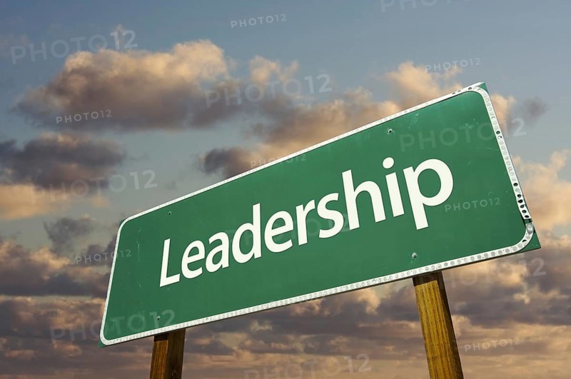 Leadership green road sign with dramatic blue sky and clouds