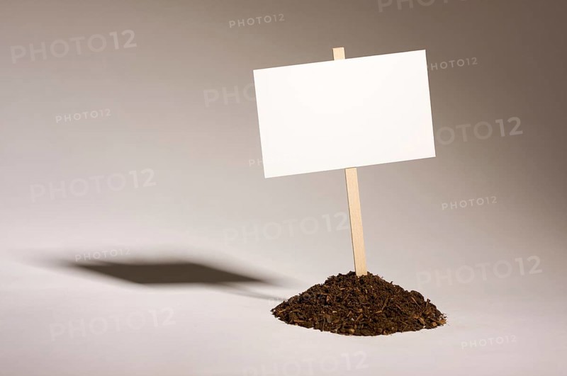 Blank white sign in mount of dirt ready for your own message