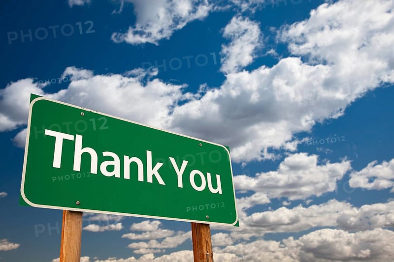 Thank you green road sign with copy room over the dramatic clouds and sky