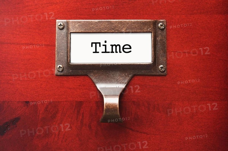 Lustrous wooden cabinet with time file label in dramatic light