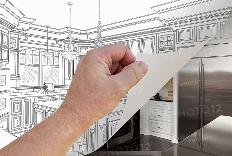 Male hand turning page of custom kitchen drawing to finished photograph underneath