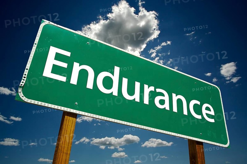 Endurance road sign with dramatic clouds and sky