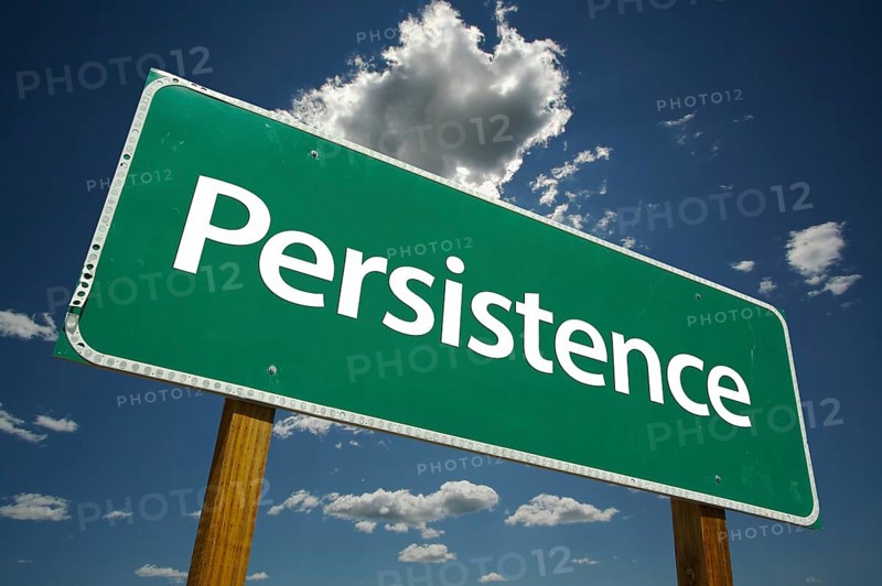 Persistence green road sign with dramatic clouds and sky