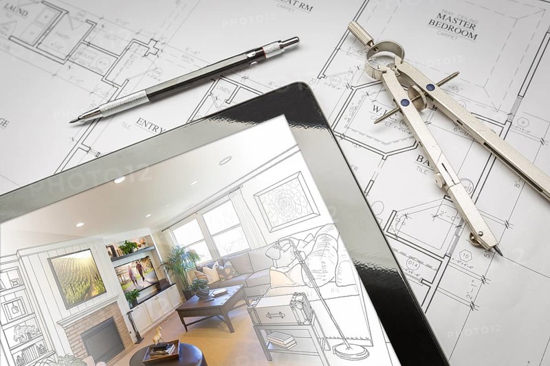 Computer tablet showing living room illustration sitting on house plans with pencil and compass