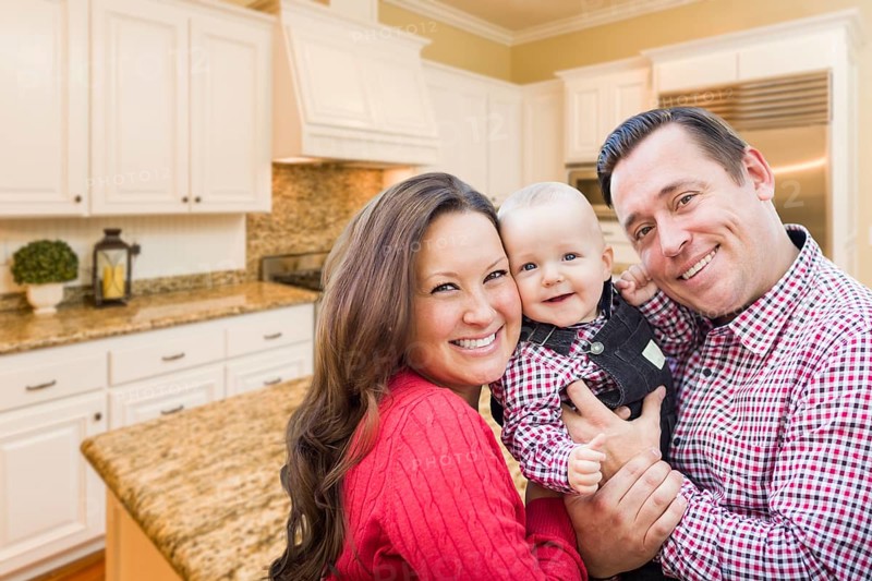 Young happy family inside beautiful custom kitchen