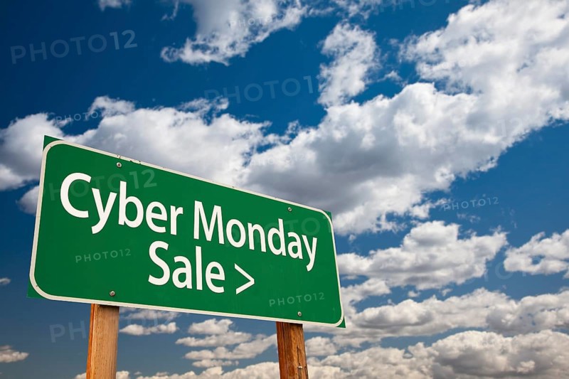 Cyber monday sale green road sign with dramatic clouds and sky