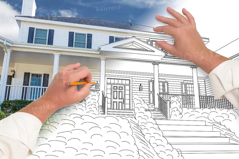 Male hands sketching with pencil the outline of a house with photo showing through