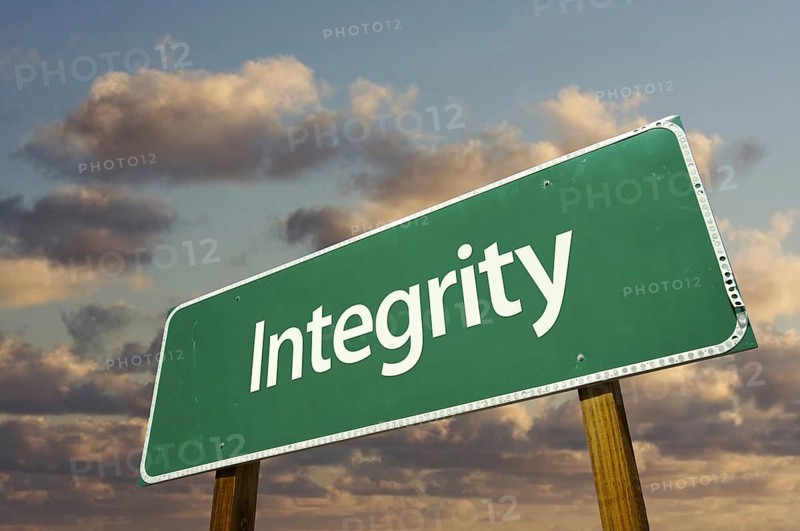 Integrity green road sign with dramatic blue sky and clouds