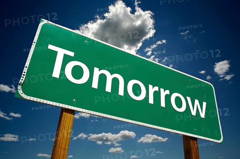 Tomorrow road sign with dramatic clouds and sky