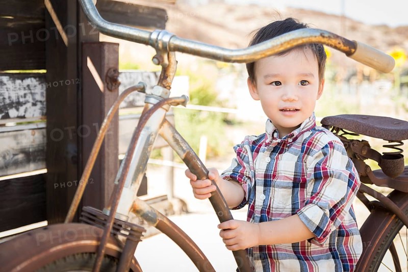 Cute mixed-race young boy having fun on the bicycle
