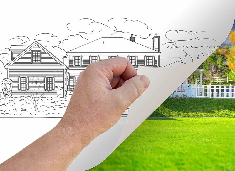 Male hand turning page of custom home photograph to drawing underneath