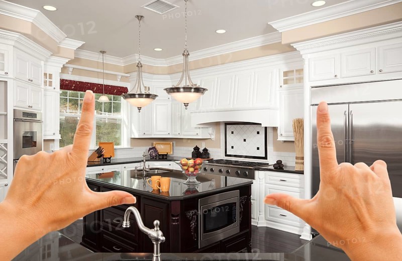 Female hands framing A beautiful custom kitchen interior