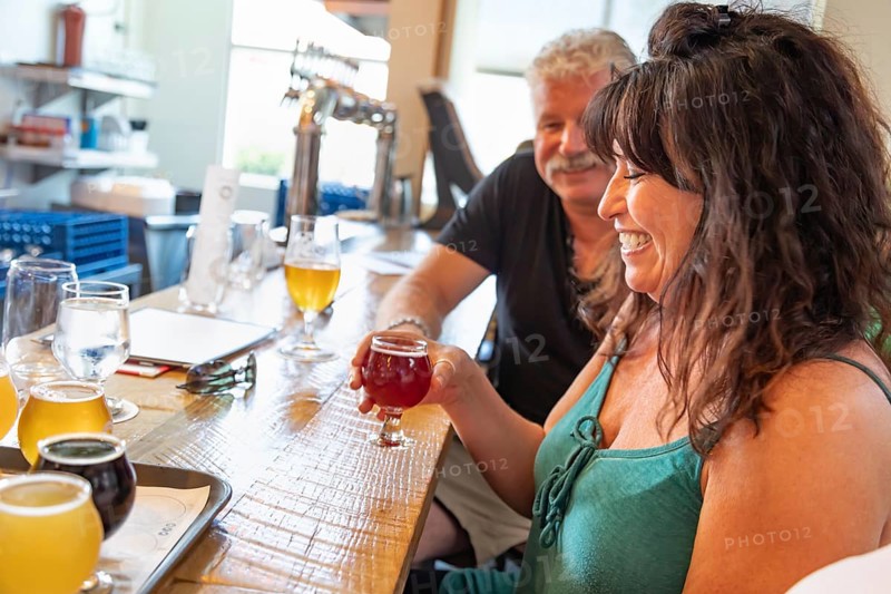 Group of friends enjoying glasses of micro brew beer at bar