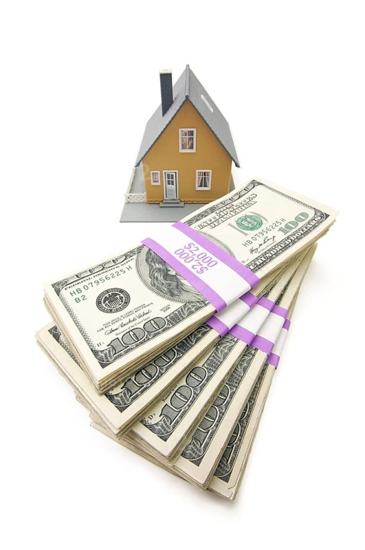 Home and stacks of money isolated on a white background