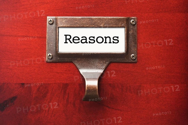 Lustrous wooden cabinet with reasons file label in dramatic light