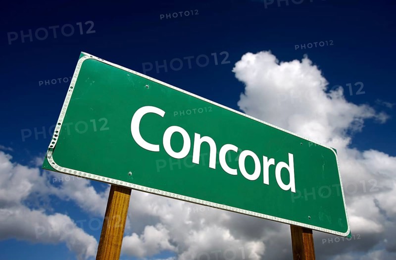 Concord road sign with dramatic blue sky and clouds