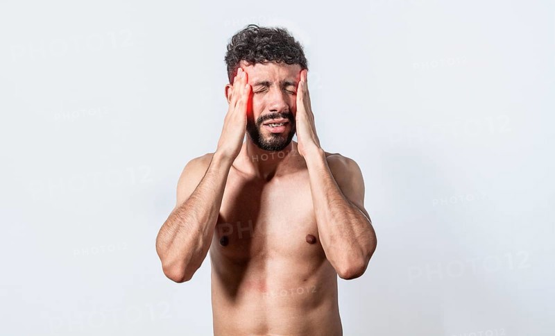Shirtless man with headache