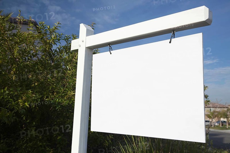 Blank real estate sign in neighborhood ready for your own message