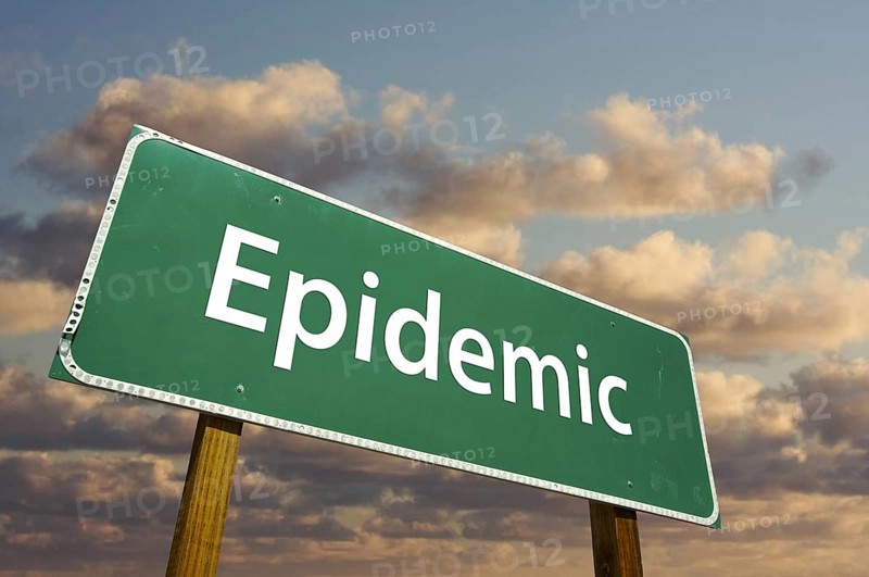 Epidemic green road sign with dramatic clouds and sky