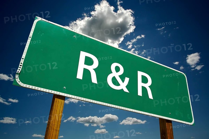 R and R road sign with dramatic clouds and sky