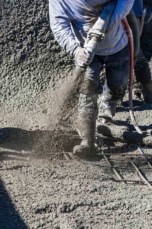Pool construction worker shooting concrete