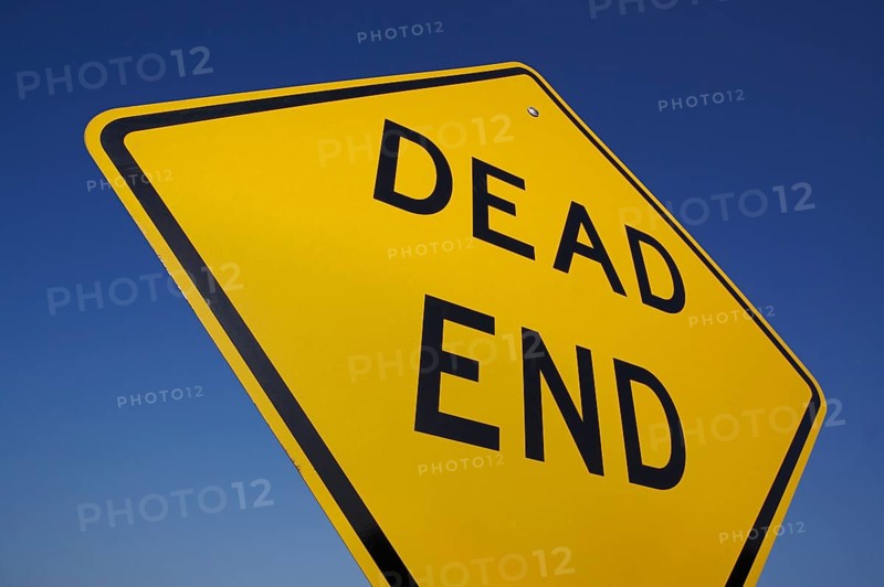 Dead end traffic sign against deep blue sky