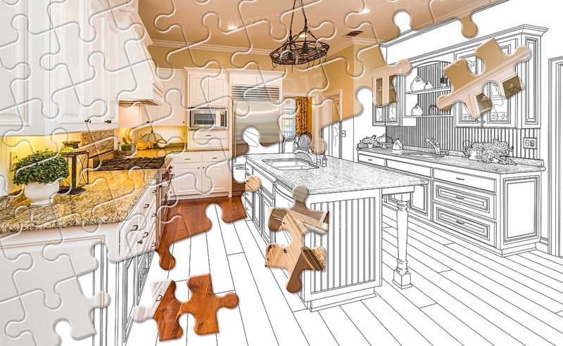 Puzzle pieces fitting together revealing finished kitchen build over drawing