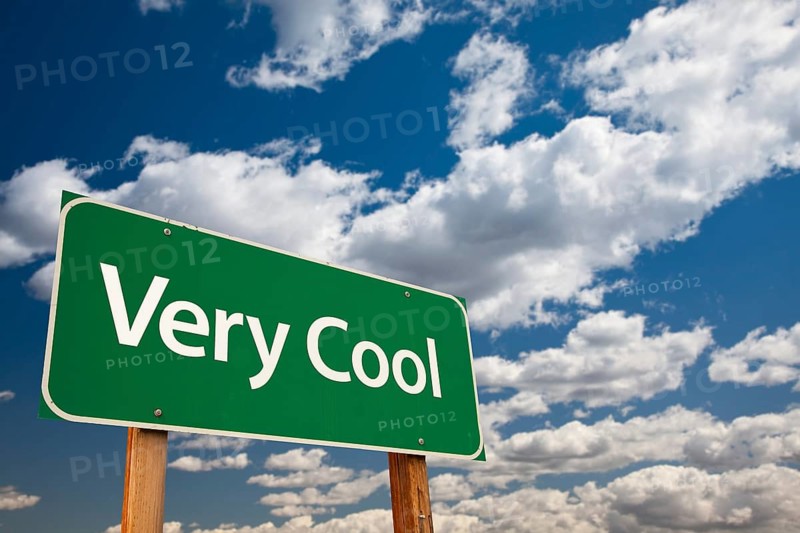Very cool green road sign with dramatic clouds and sky
