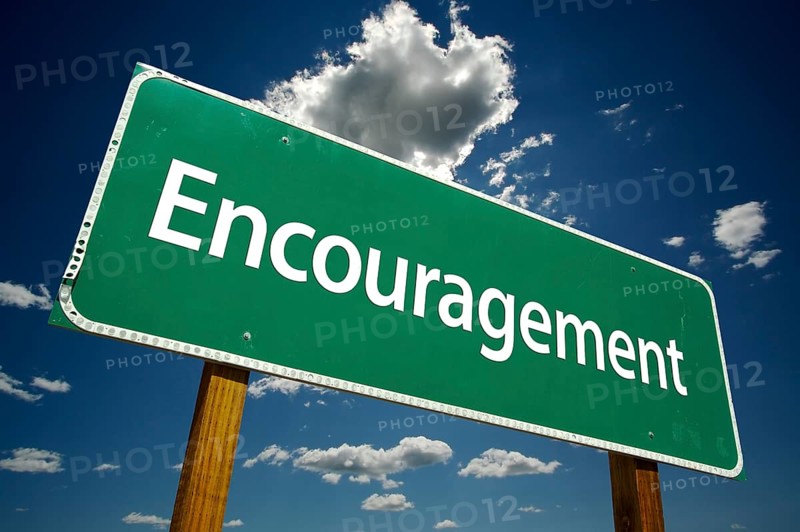 Encouragement road sign with dramatic clouds and sky