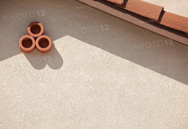 Abstract of new stucco wall and roof from house