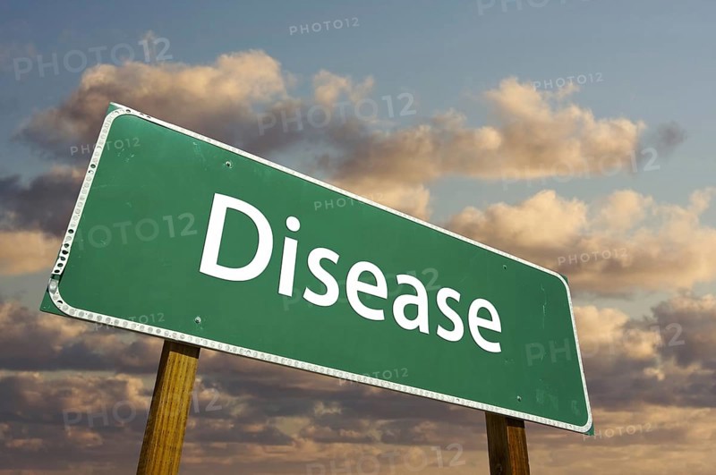 Disease green road sign with dramatic clouds and sky
