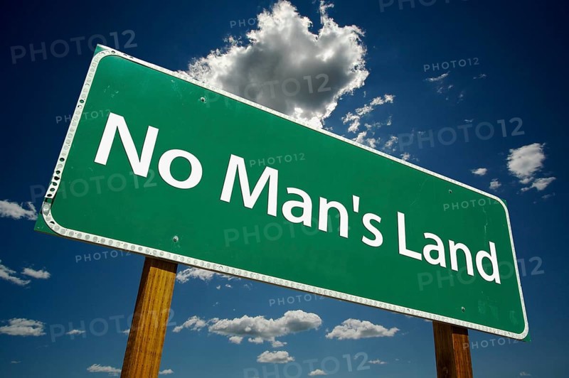 No man's land green road sign on dramatic clouds and blue sky