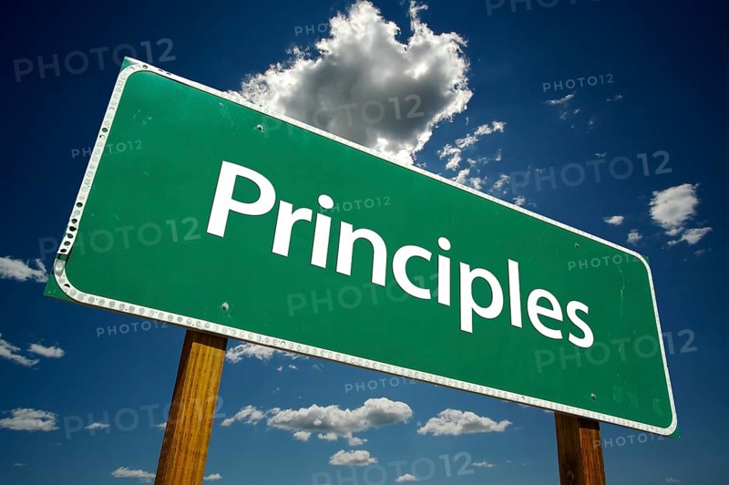 Principles road sign with dramatic clouds and sky