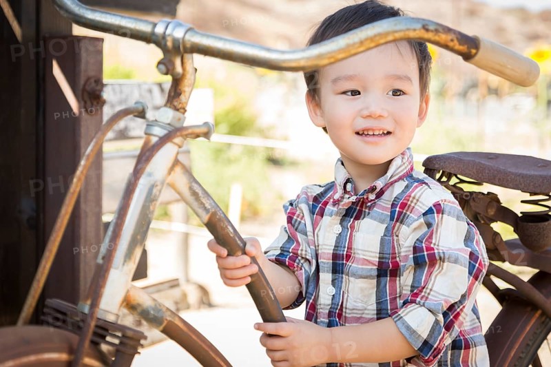 Cute mixed-race young boy having fun on the bicycle