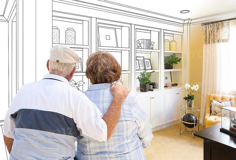 Senior couple facing custom built-in shelves and cabinets design drawing gradating to finished photo