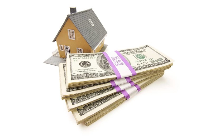 Home and stacks of money isolated on a white background