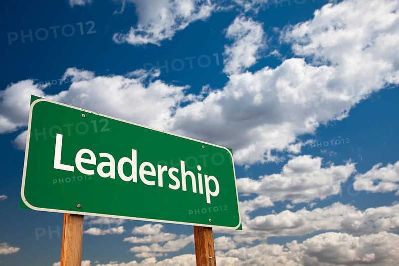 Leadership green road sign with copy room over the dramatic clouds and sky