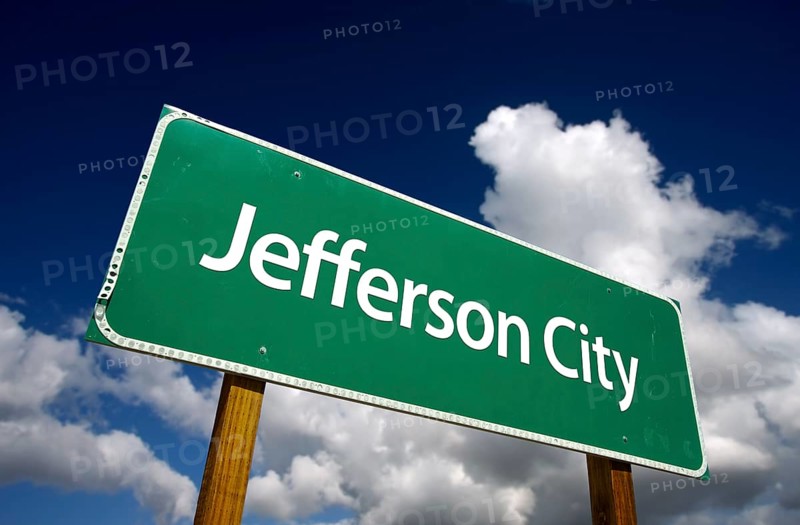 Jefferson city road sign with dramatic blue sky and clouds