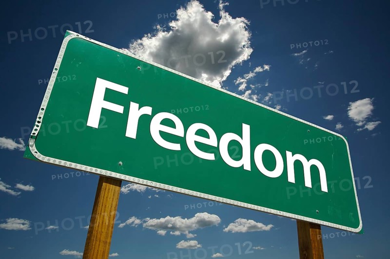 Freedom road sign with dramatic clouds and sky