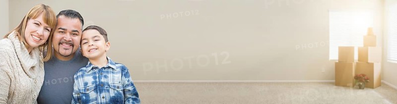 mixed-race family in empty room with moving boxes banner