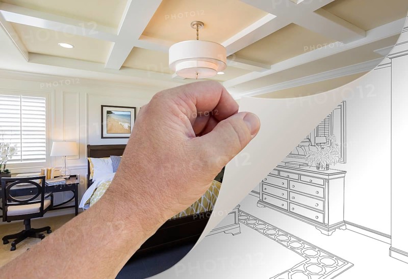 Male hand turning page of custom bedroom photograph to drawing underneath
