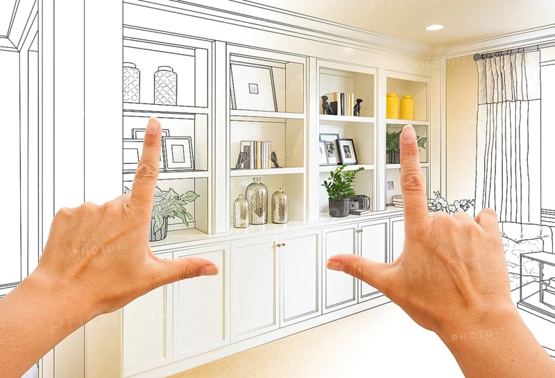 Hands framing custom built-in shelves and cabinets design drawing with section of finished photo