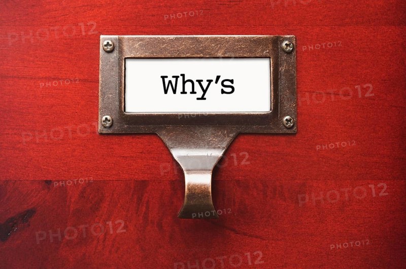 Lustrous wooden cabinet with why's file label in dramatic light