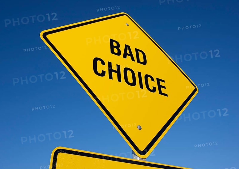 Bad choice yellow road sign against a deep blue sky with clipping path