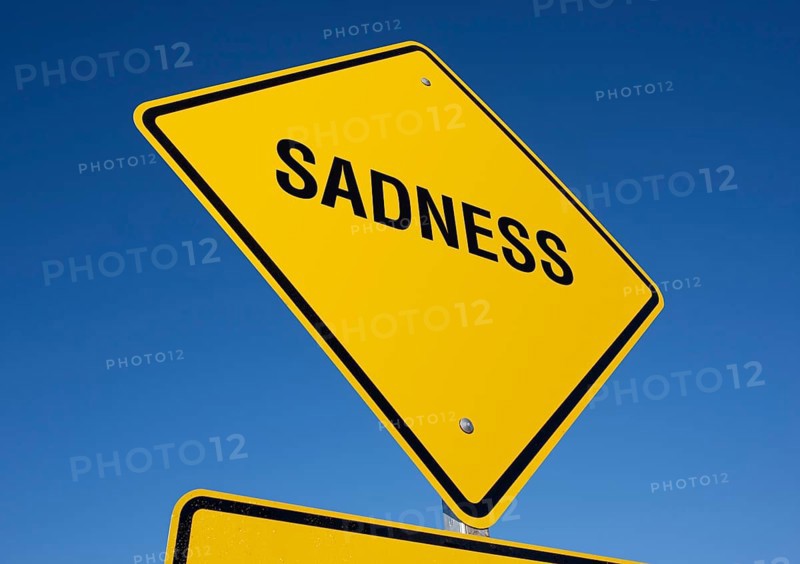 Sadness yellow road sign against a deep blue sky with clipping path