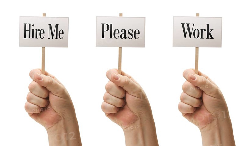 Three signs in male fists saying hire me
