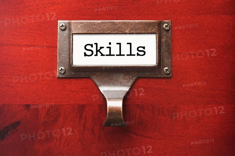 Lustrous wooden cabinet with skills file label in dramatic light