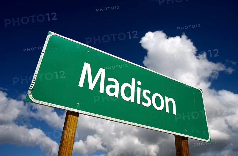 Madison road sign with dramatic blue sky and clouds