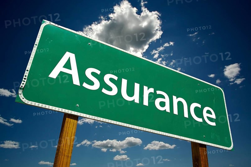 Assurance road sign with dramatic clouds and sky