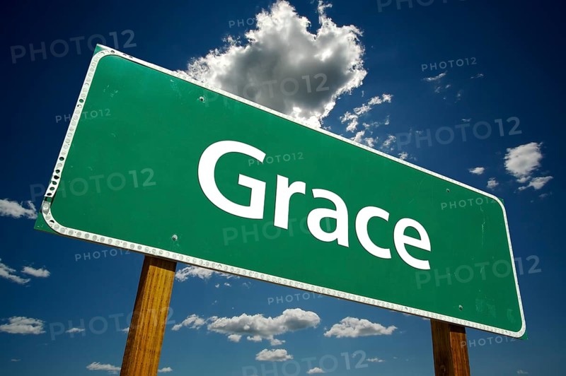 Grace green road sign with dramatic clouds and sky